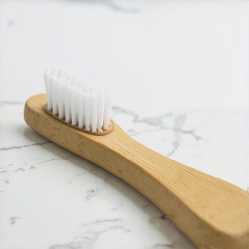 Professional tongue scraper and toothbrush on a marble surface for oral hygiene.